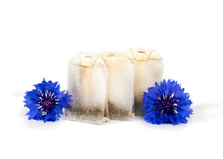 herbal tea bag with blue flowers isolated on white backgroundの写真素材