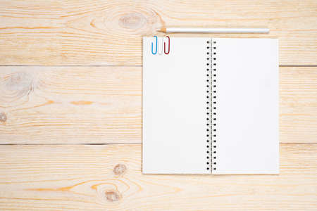 open empty notepad with white pencil on wooden tableの写真素材