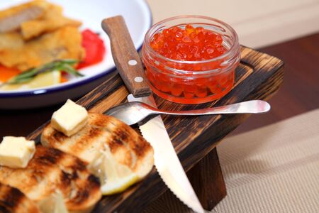 Great appetizer of salmon caviar and wine. Sandwiches with red caviar and wine.