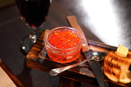 Great appetizer of salmon caviar and wine. Sandwiches with red caviar and wine.