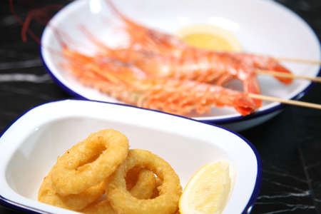 Langoustines and beer. Beer and seafood snacks. Langoustines, beer, squid rings.