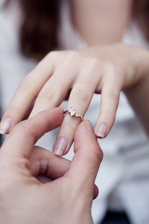 an image of situation of inserting engagement ring into a fingerの写真素材