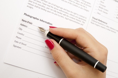 Female hand signing contract の写真素材