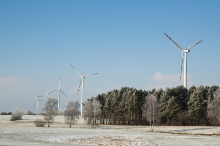 An image of winter scenery with windturbines in the background の写真素材