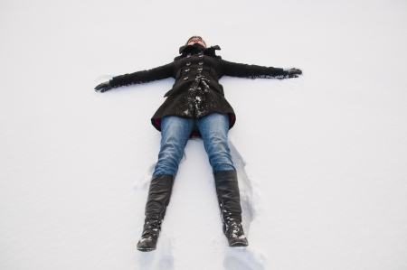 An image of girl lying at groung in winterの写真素材