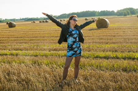 An image of brunette girl portrait and straw bale の写真素材