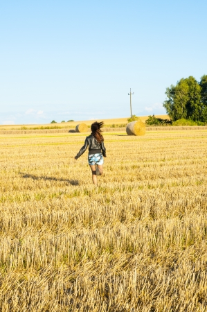 An image of brunette girl portrait and straw bale の写真素材
