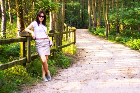 An image o girl walking through the forest pathwayの写真素材