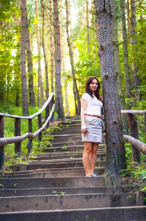 An image o girl walking through the forest pathwayの写真素材