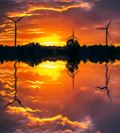 A silhouette of windturbines on a amazing sunsetの写真素材