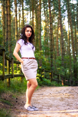 An image o girl walking through the forest pathwayの写真素材
