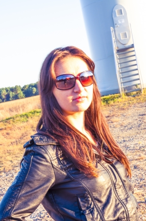 Girl standing on entrance to windturbineの写真素材