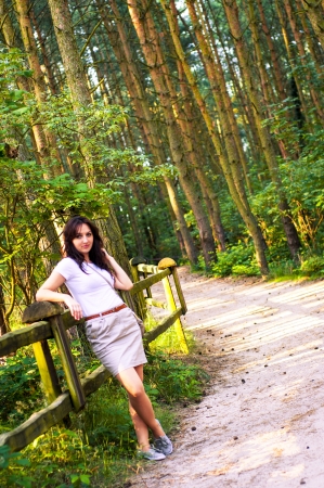An image o girl walking through the forest pathwayの写真素材