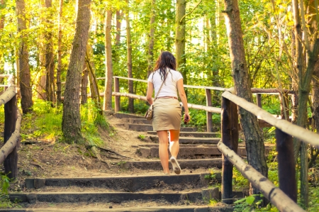 An image o girl walking through the forest pathwayの写真素材