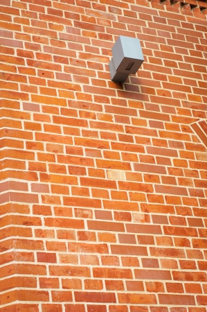 An image of security camera instaleed on red brick wallの写真素材