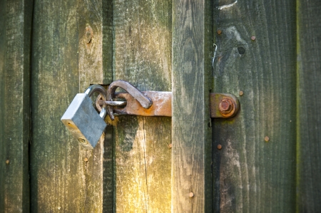 An image of closed old wooden door with padlockの写真素材