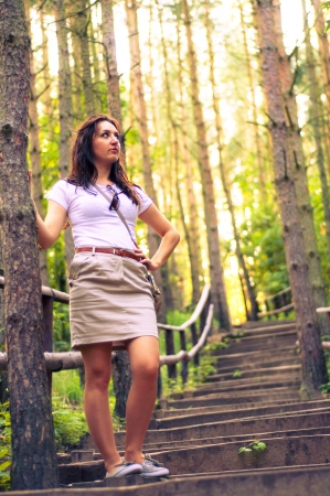 An image o girl walking through the forest pathwayの写真素材