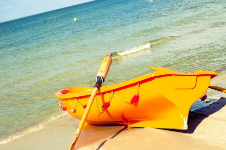 An image of orange rescue boat on the beach of baltic seaの写真素材