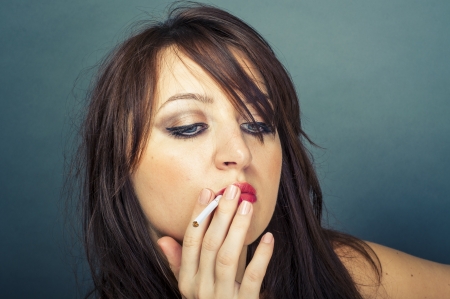 An image of beautiful woman smokes a cigarette の写真素材