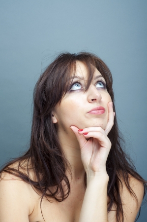 an image of young brunette woman thinkingの写真素材