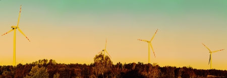 An image of windturbines over the sunsetの写真素材