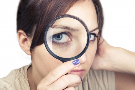 an image of girl with magnifying glass over her faceの写真素材