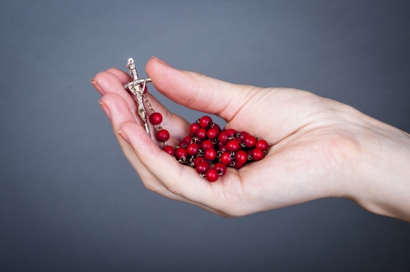 an image of rosary on female handの写真素材