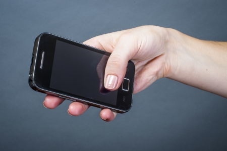 an image of black mobile phone held by girlの写真素材