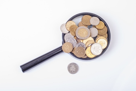 an image of coins lying on magnifying glassの写真素材
