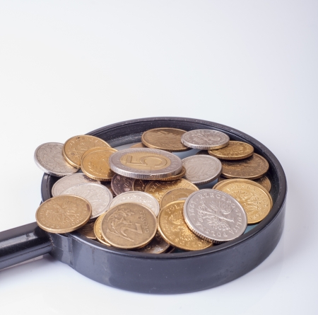 an image of coins lying on magnifying glassの写真素材