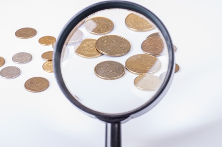 an image of coins lying on magnifying glassの写真素材