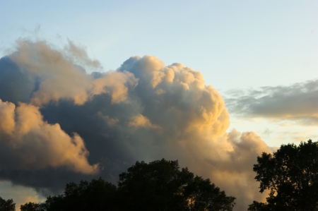 An image of Dark sky with storm clouds during sunset