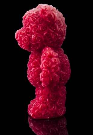 An image of red candle bear with roses surfaceの写真素材
