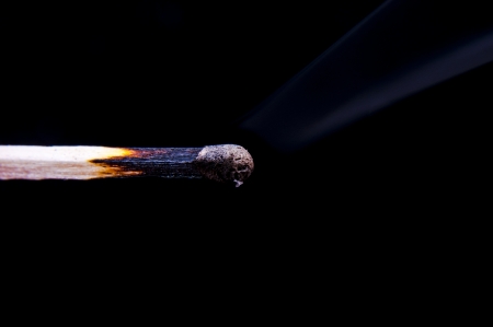 An image of firing match on black backgroundの写真素材