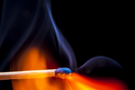 An image of firing match on black backgroundの写真素材