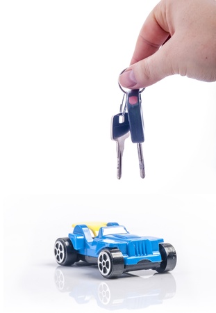 An image of keys above toy blue carの写真素材
