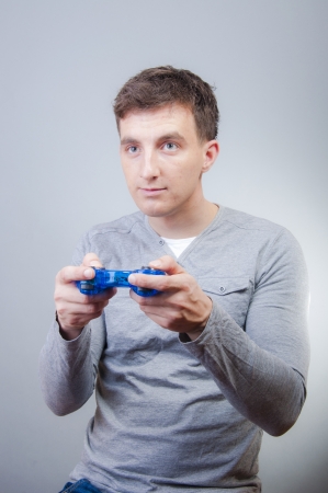 An image of boy holding joystick and playing games の写真素材