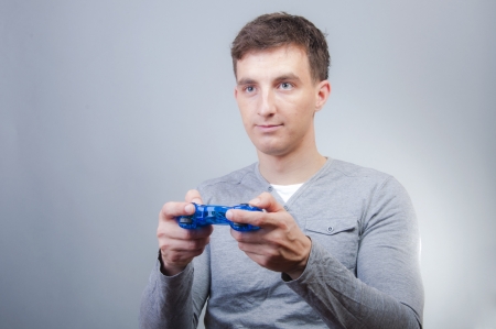 An image of boy holding joystick and playing games 