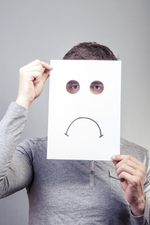 An image of man holding paper with emotionsの写真素材