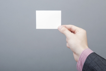 An image of businessmen holding blank cardの写真素材
