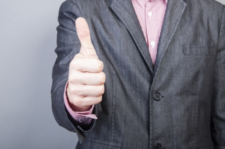 An image of Businessmen handshake  isolated on gray backgroundの写真素材