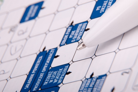 An image of crossword and white pen