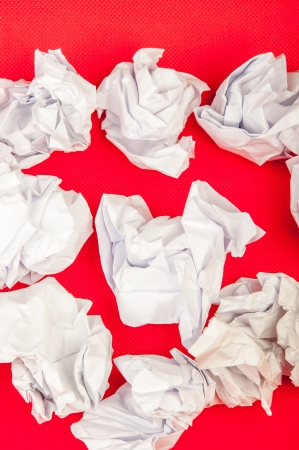 An image of paper rubbish isolated on red backgroundの写真素材