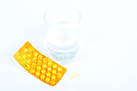 An image of headache pills and glass of water