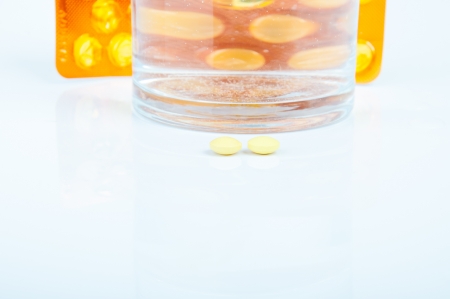 An image of headache pills and glass of water