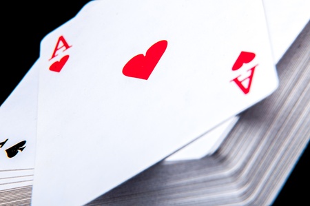 An image of playing cards, dice and money
