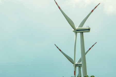 an image of wind turbines on a sunny day