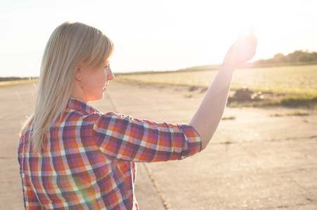 portrait of freckled blonde outside wearing a plaid shirtの写真素材