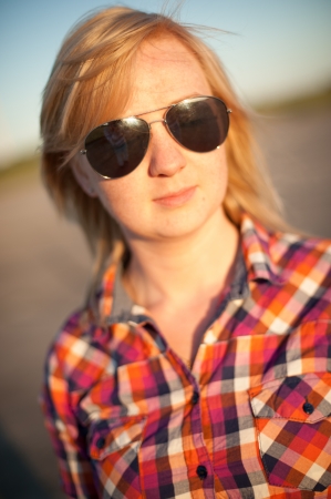 portrait of freckled blonde outside wearing a plaid shirtの写真素材