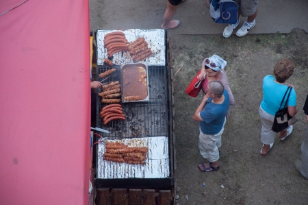 SZCZECIN - AUGUST 04: Visitors qued for grilled sasuage at lunch time during The Tall Ships Races 2013, August 04, 2013 in Szczecin, Poland.のeditorial素材